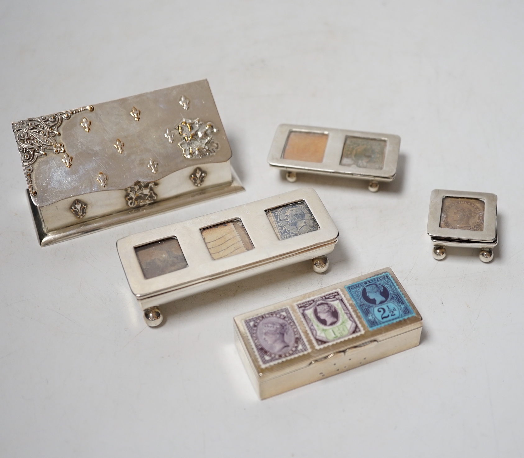 Four assorted late 19th/early 20th century silver stamp boxes, including triple compartment, one with enamelled 'stamps', largest 9cm and one plated stamp box.